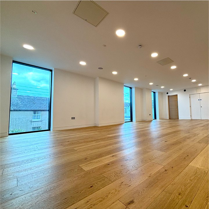 The yoga hall at The Lark: a bright room with an oak floor and tall windows